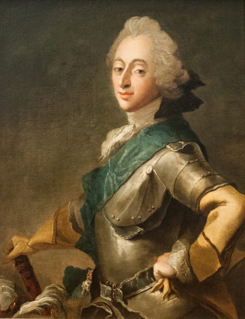 man in armor with blue sash